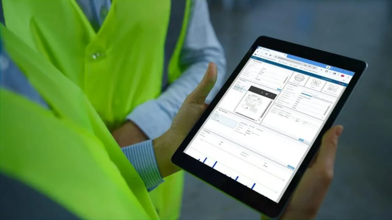 A manufacturing professional viewing production information on a tablet